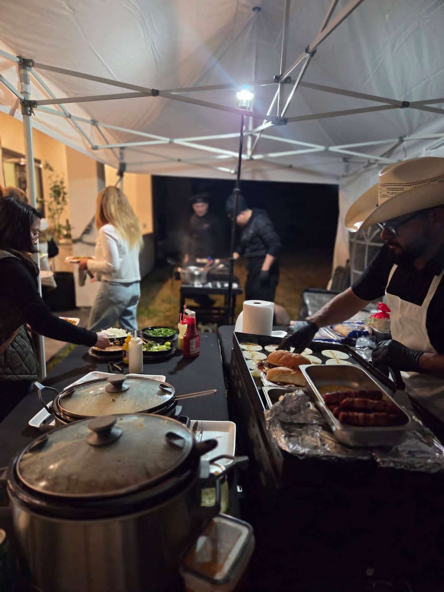 Live taco station serving guests at an evening event