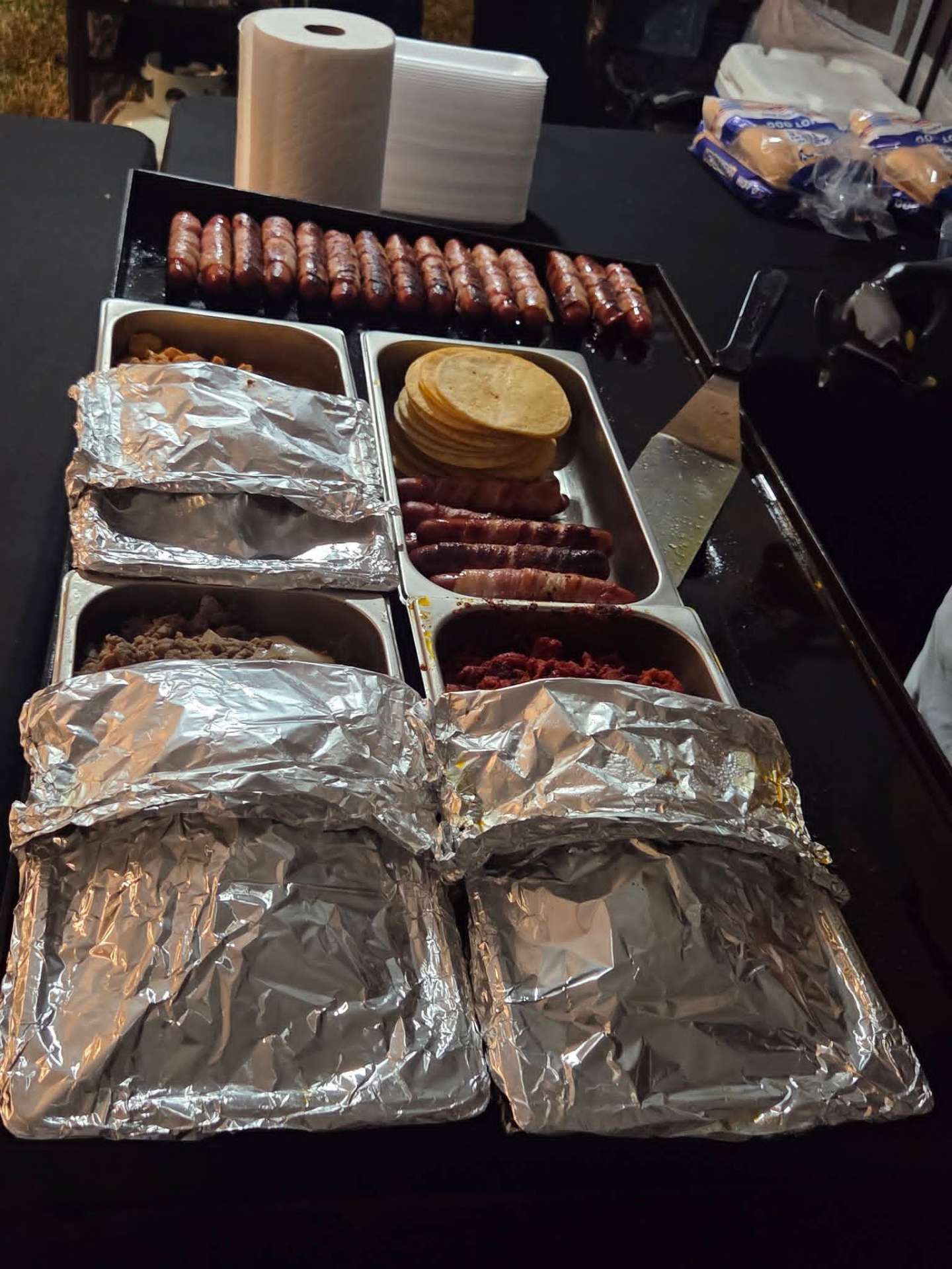Bacon-wrapped hot dogs, tortillas and meat trays ready to serve