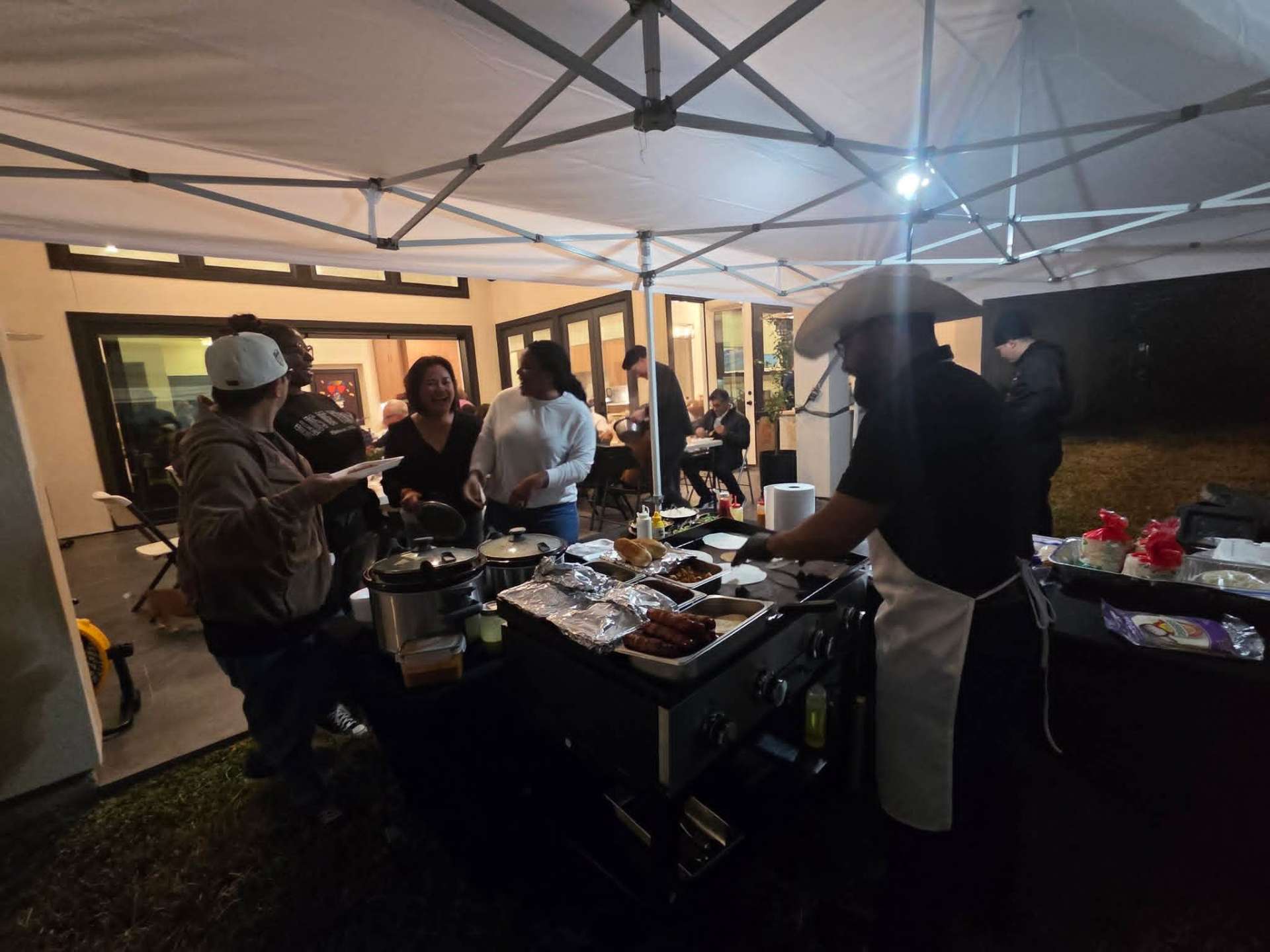 Guests lined up for street tacos under the catering tent