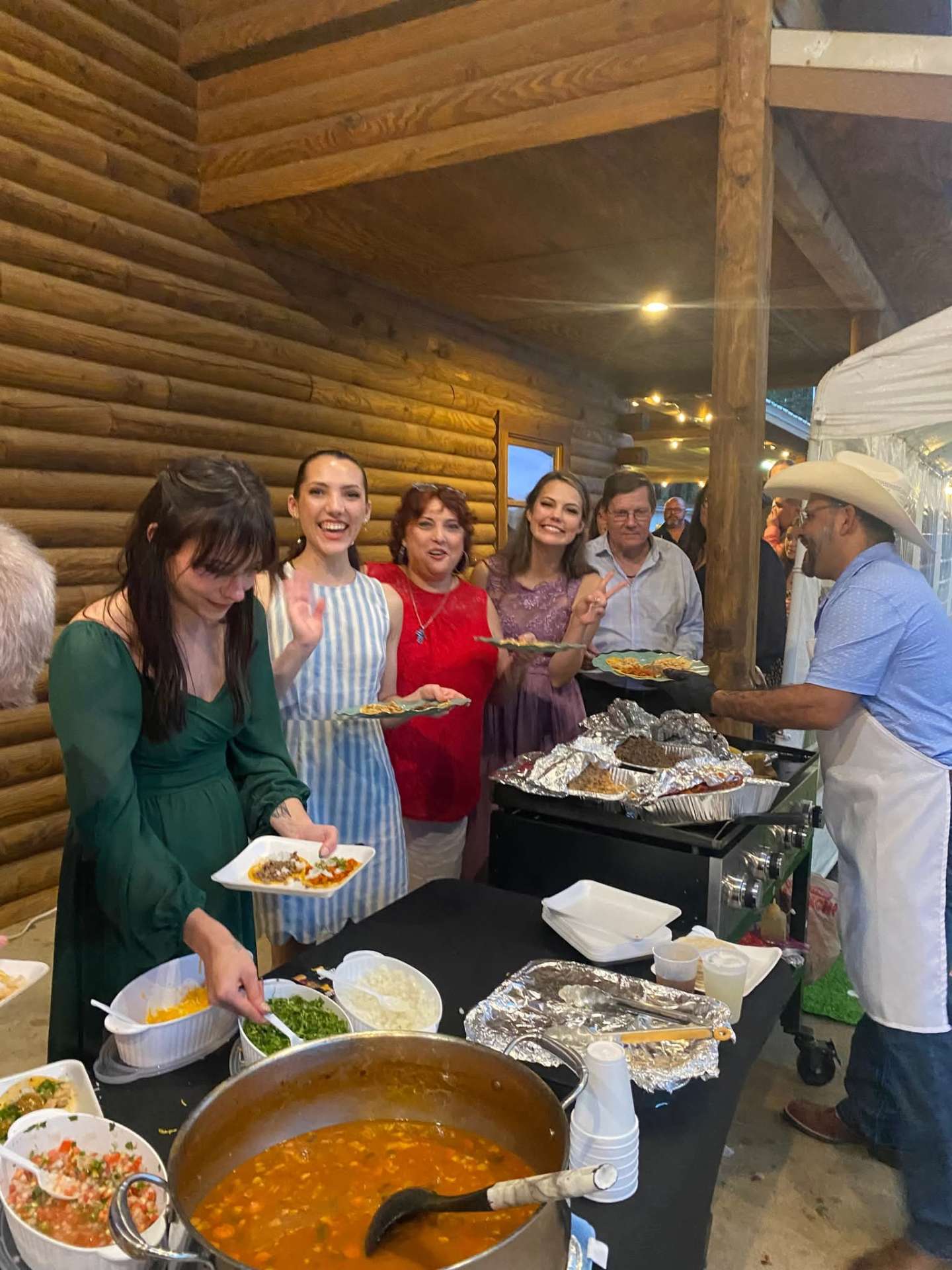 Guests serving themselves tacos at a party