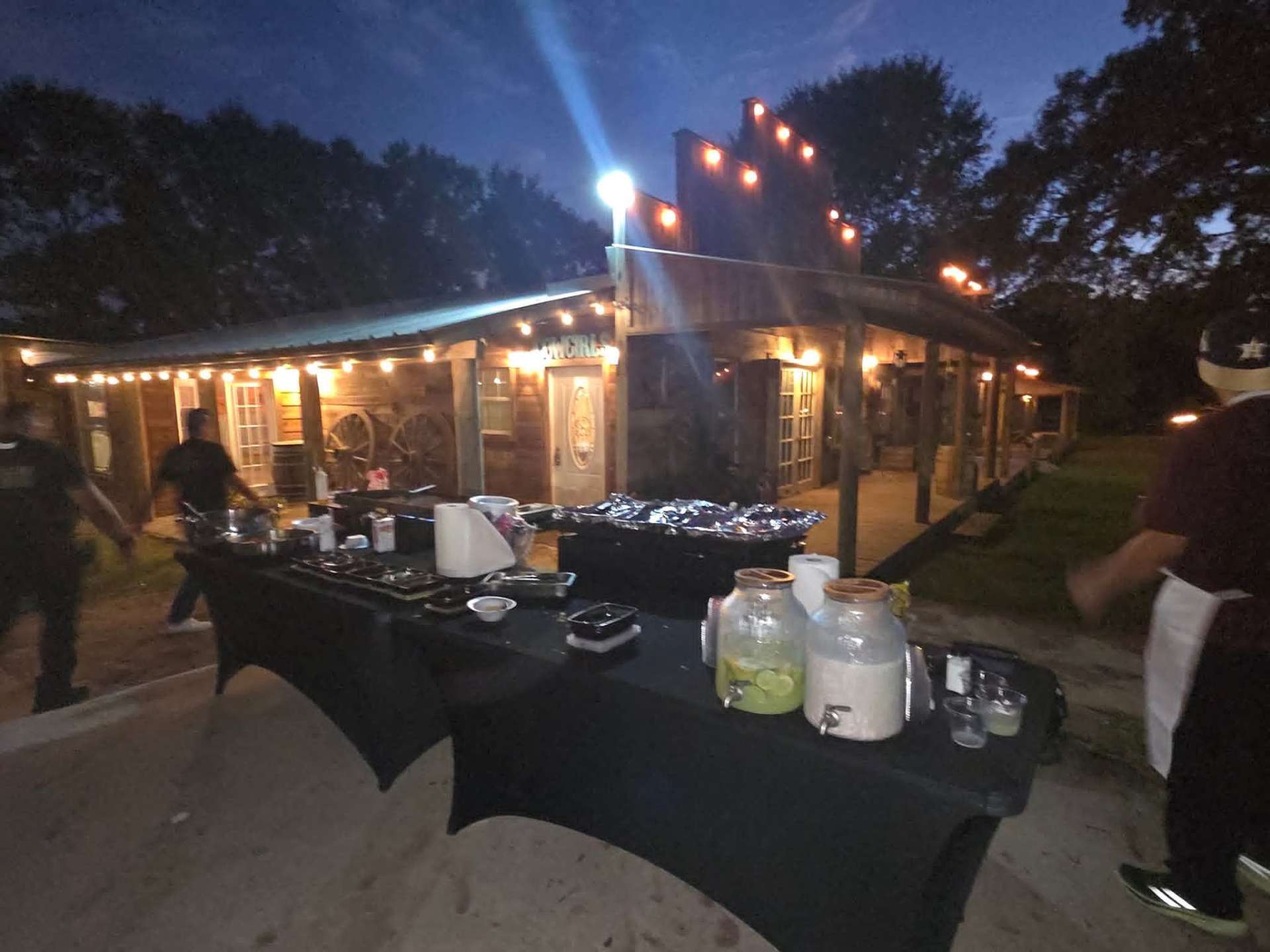 Full catering setup with aguas frescas at an outdoor venue
